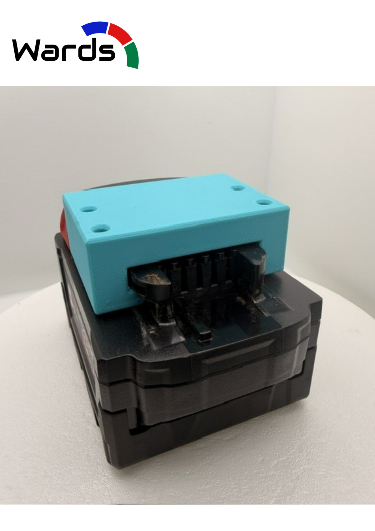 Milwaukee M18-compatible battery holder mounted in a workshop