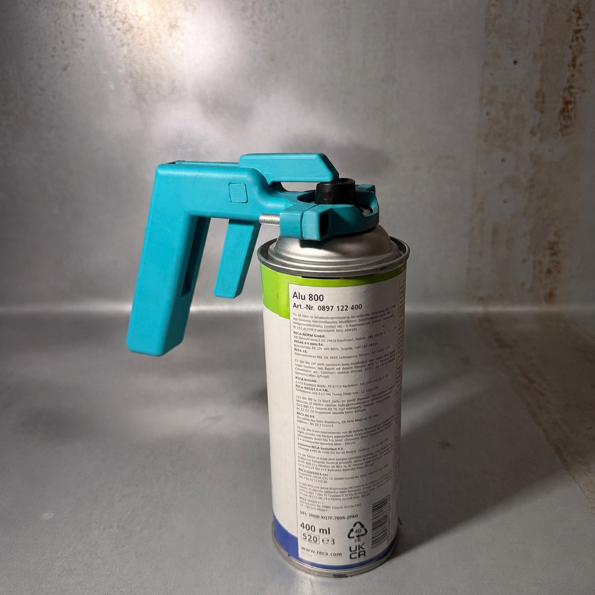 Adjustable aerosol trigger handle in Turquoise fitted to aerosol can