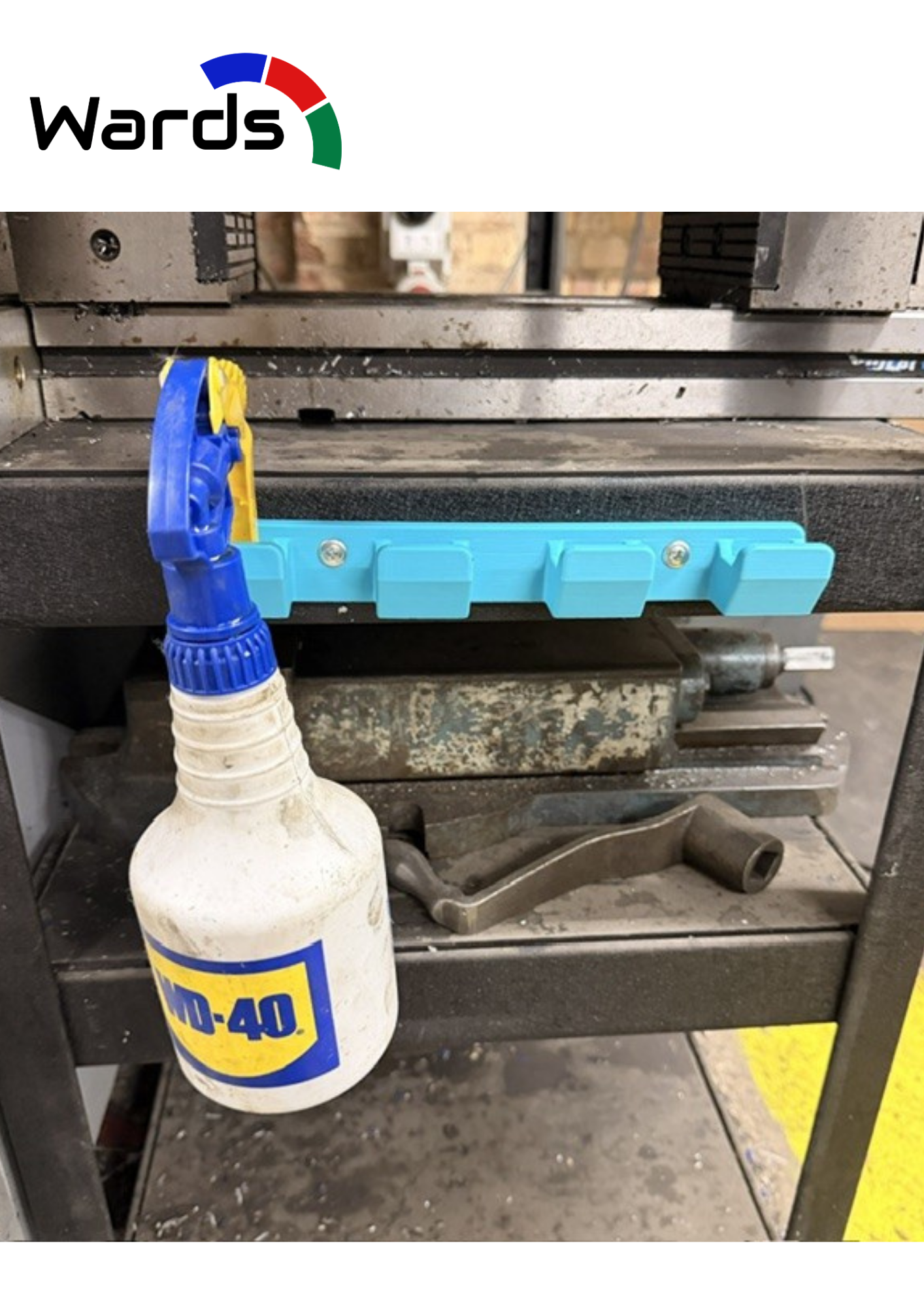 Four-slot wall holder storing a trigger spray bottle in a workshop