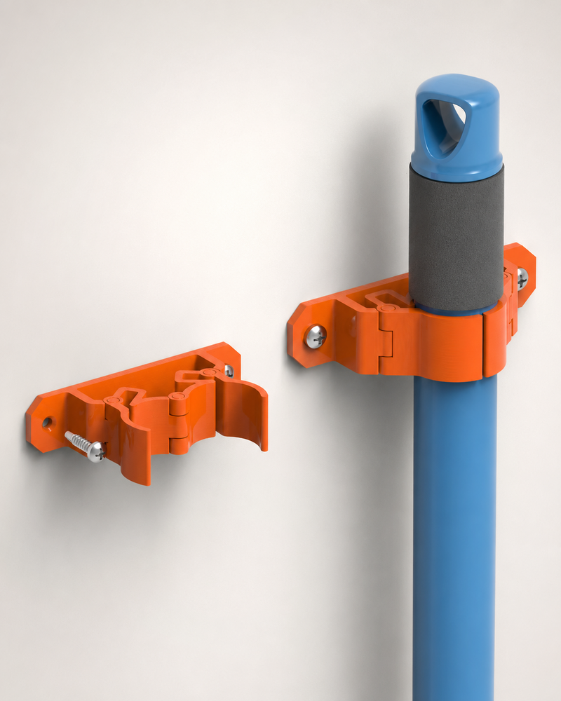 Orange wall-mounted broom holder shown open and securely gripping a broom handle