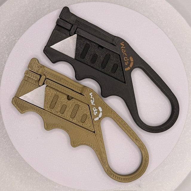 Wards branded compact utility knives in black and gold shown from alternate angle